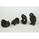 A collection of four hand carved wooden Chinese netsuke in the form of various animals.