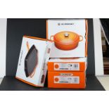 Four boxed Le Creuset items of cookware to include a signature oval lidded casserole dish, signature