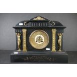 An antique French slate mantle clock with gilt decoration.