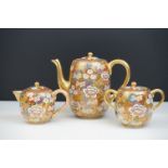 Japanese Satsuma Three Piece Coffee Set decorated with flowers on a gilt ground, marks to base,