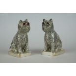 Pair of dog condiments stamped 800, with ruby eyes