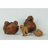 A collection of four hand carved wooden Chinese netsuke in the form of animals.
