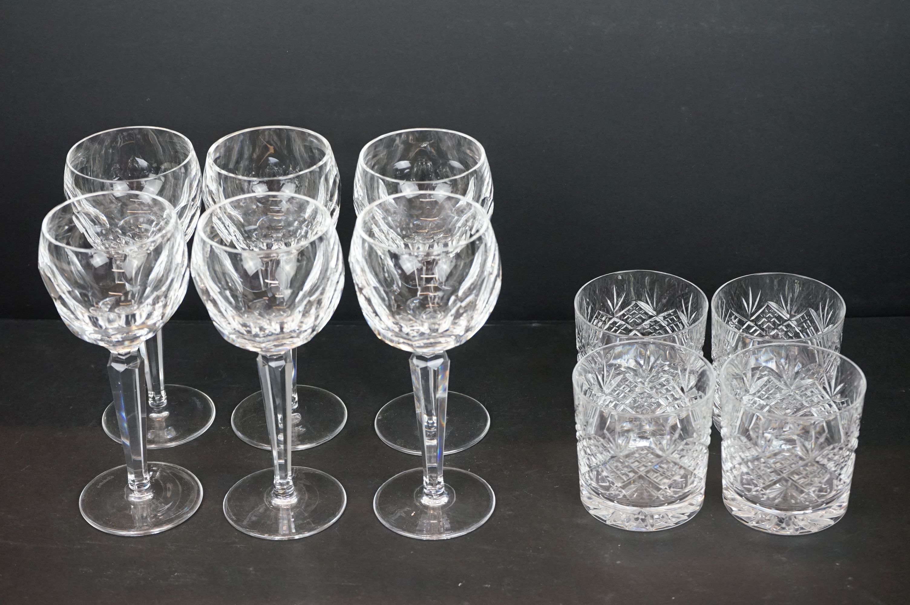 Six Waterford Crystal wine glasses together with a set of four hobnail cut glass tumblers by Thomas