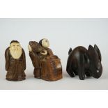 A collection of three hand carved wooden Chinese Netsuke to include a signed example.