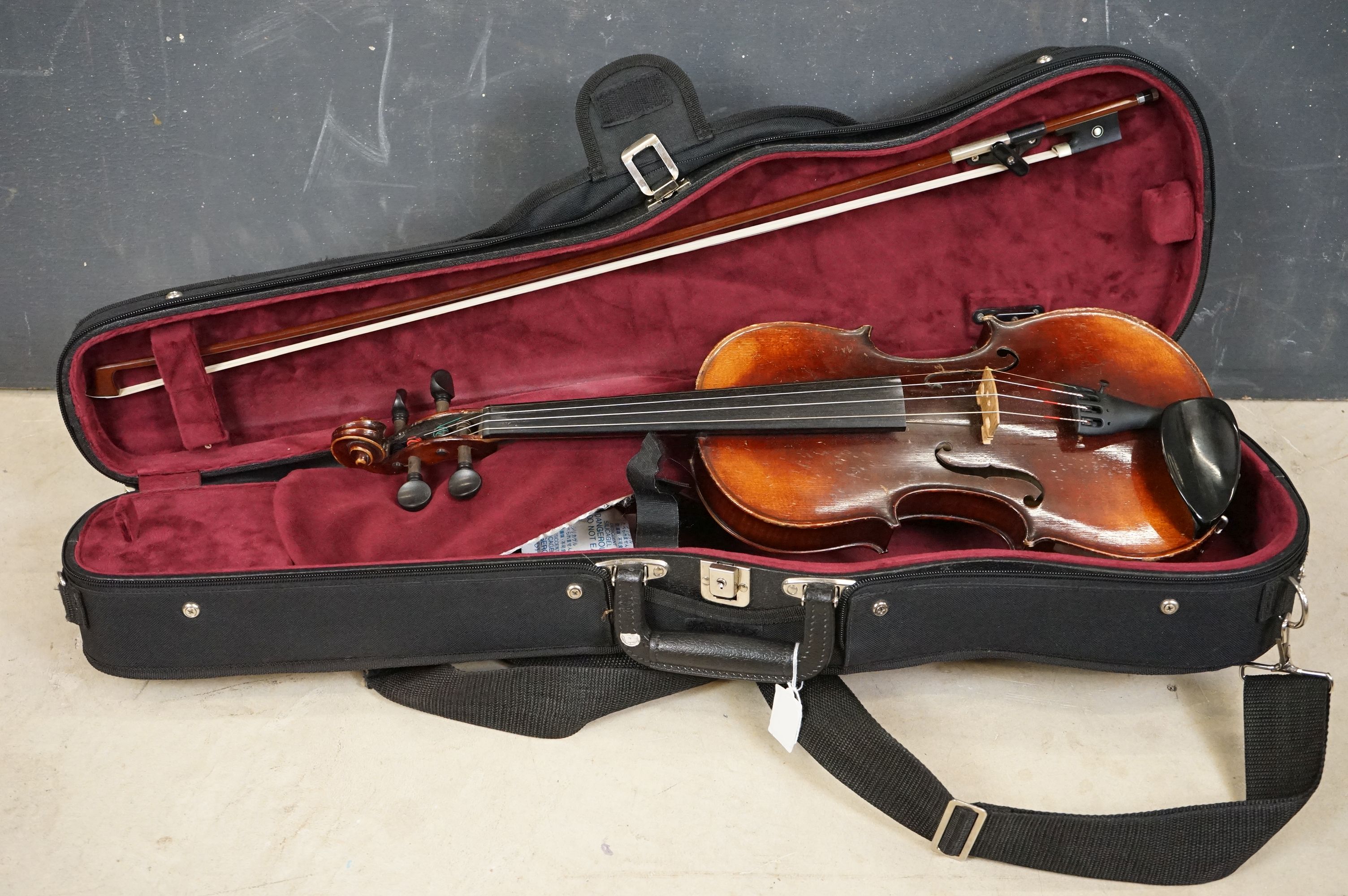 A violin and bow, unmarked, possibly German (Length of back 34cm) with Everest support together with