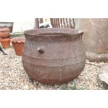 A large cast iron Cauldron, measures approx 50cm in height with an open width of approx 60cm.