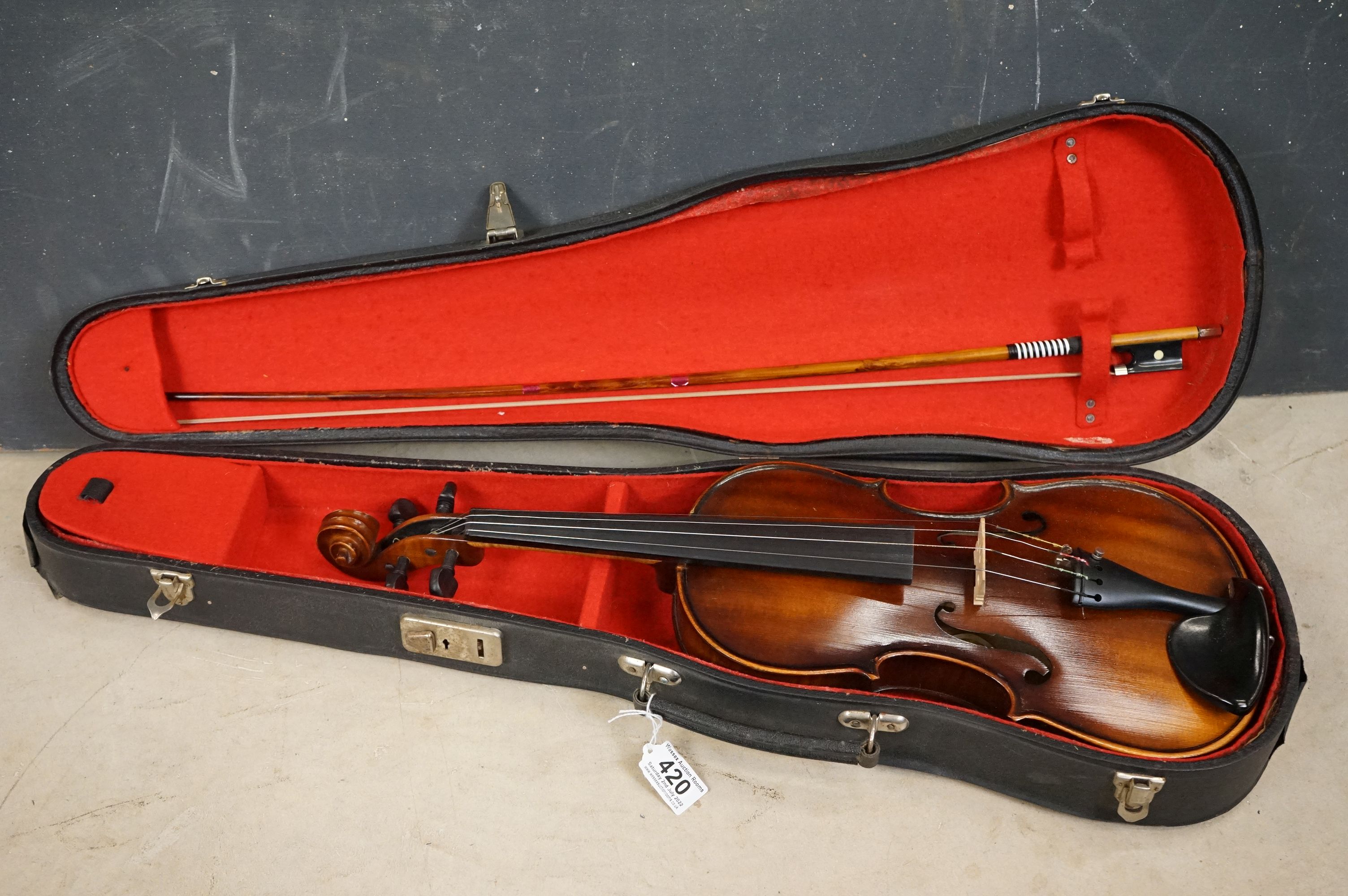 A violin and bow together with hardcase, import label for Boosey & Hawkes to inside of violin.