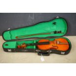 A Childs size violin and bow together with hardcase.