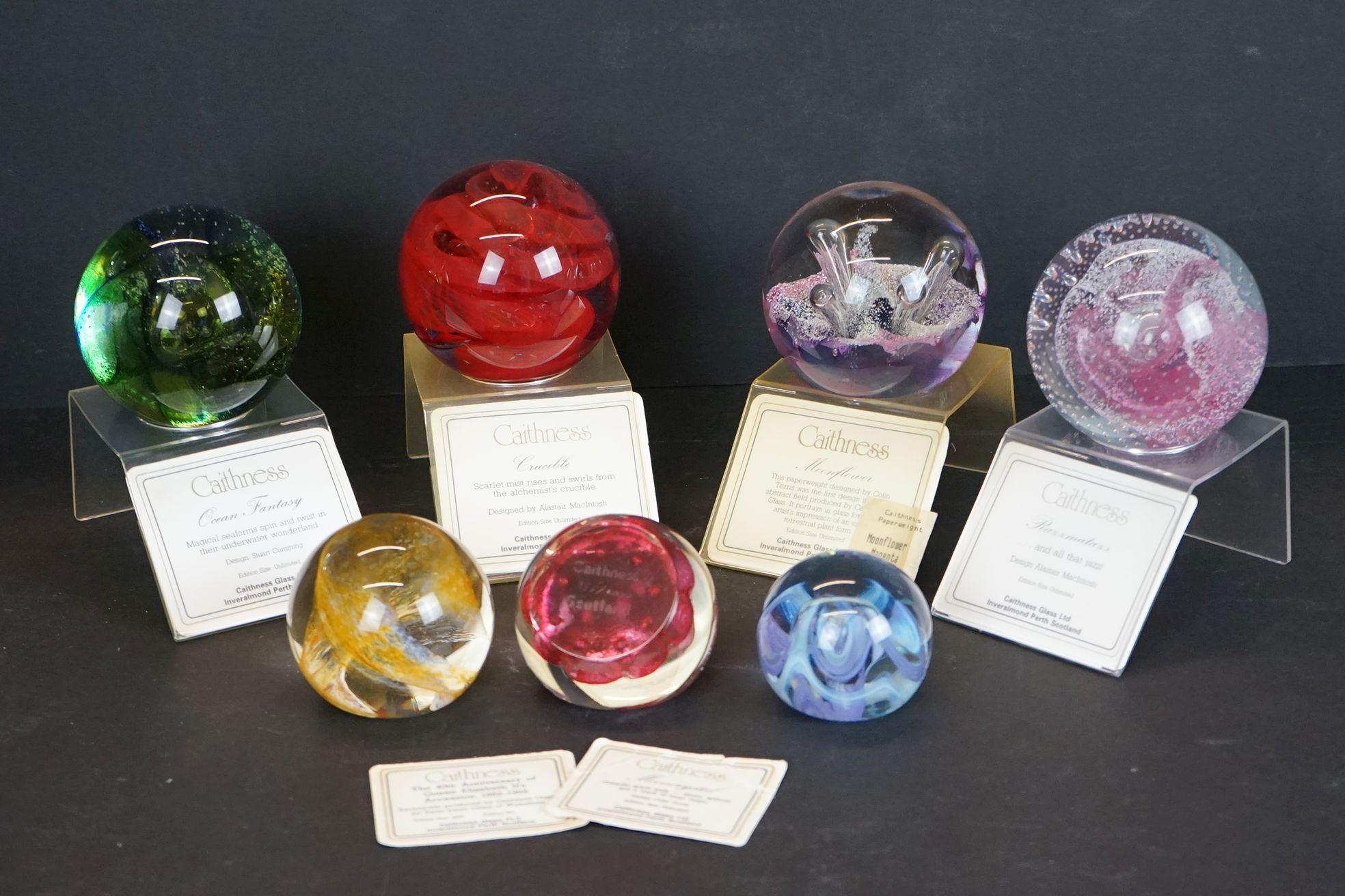 Seven Caithness glass paperweights to include Mooncrystal, Pastel, 40th Anniversary of Queen