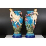 Pair of Continental Majolica Baluster Vases with relief decoration of scantily dressed women sat