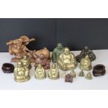 A collection of oriental Buddha ornaments to include brass and wood examples.