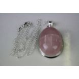 A substantial silver and rose quartz pendant necklace.