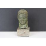 A bronze bust of a greek of Egyptian god mounted on a marble plinth, approx 12cm in height.