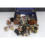 A collection of mainly vintage costume jewellery contained within a wooden box.