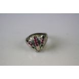 A silver and ruby set cat dress ring.