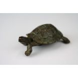 A bronze figure of a tortoise, approx 5cm in length.