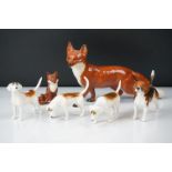 Beswick foxes and hounds to include a 1016 large fox (22cm long), small seated fox and 4 hounds (6)