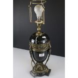 A black marble table lamp of classical form with swagger decoration.