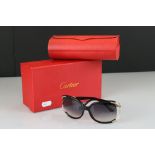 A pair of ladies Leopard sunglasses marked Cartier, complete with box and case.