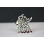 A silver parrot pendant brooch on ruby platform.