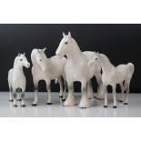 Four Beswick dappled grey horses to include an 818 shire horse (23 cm long), swish-tail horse (a/