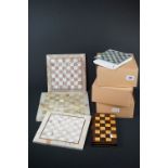 A collection of chess sets to include stone and wooden examples together with boards.