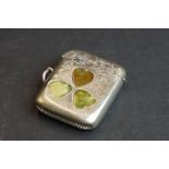 A silver plated vesta cased with agate three leaf clover pattern to the front.