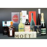 A small collection of bottled alcohol to include Cointreau, Moet & Chandon Champaign and Remy Martin