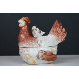 Ceramic hen on nest egg basket, modelled as a mother hen with attendant chicks, 18cm long