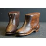 Two antique carved wooden shoe snuff boxes with sliding lids.