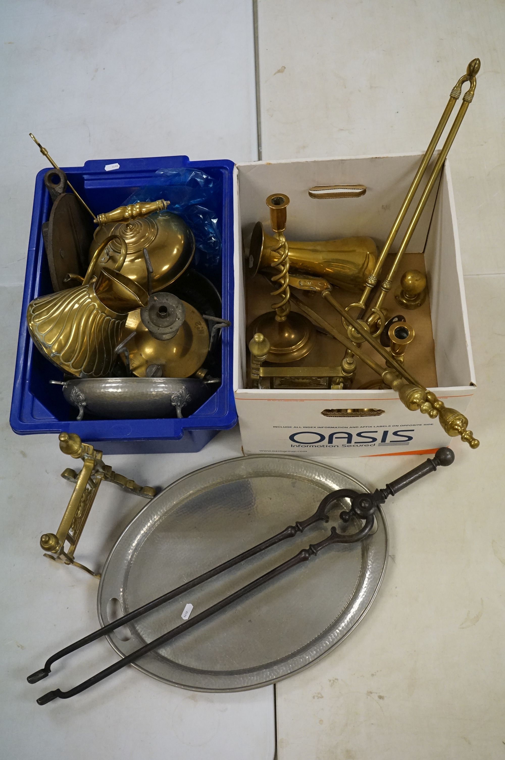 Collection of brassware to include a pair of barley twist candlesticks, fire tongs, trench art style