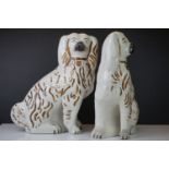 Pair of white glazed Staffordshire dogs with gilt highlights, 31cm tall