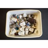 A collection of thimbles to include metal and ceramic examples.