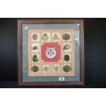 A framed and glazed collection of carved stone Chinese amulets.