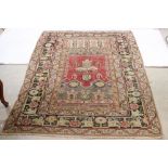 Eastern Red and Cream Ground Wool Rug with patterns within a border, 200cm x 138cm