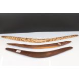 A collection of three Australian carved wooden boomerangs.