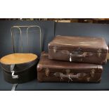 Two vintage brown leather suitcases together with a hat box.