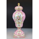 19th century Continental Porcelain Pink Ground Lidded Urn decorated with panels of flowers in a