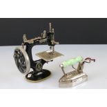 An antique cast iron miniature Singer sewing machine together with a miniature A.R.C. Chesterton