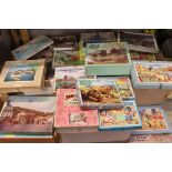 A large collection of early to mid 20th century jigsaws to include many wooden Victory examples.