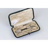 A decorative white metal pocket sewing set to include thimble, scissors, needle case...etc in