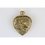 Brass heart shaped perfume bottle with embossed decoration