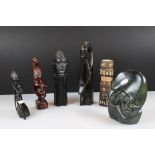A small collection of wooden and stone tribal carvings.