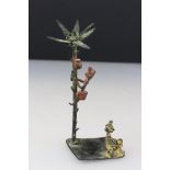 A cast metal palm tree and figural ornament.
