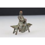 Bronze Buddha in robe, seated in the lotus position, on a bench, approx. 7cm tall