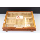 A shop display cigar cabinet with hinged glass lid.