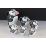 John O'Groats Pottery - Set of Three Graduating Puffin Jugs, largest 20cm high together with another