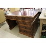 Victorian Oak Desk, heavily carved with lion masks and scrolling foliage, red leather inset top,