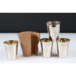 Set of four gilt lined plated cups in a leather case