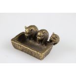 Metal sculpture of three pigs in a trough, length approx. 5cm